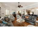 Open-concept living room with hardwood floors, neutral furniture, and a ceiling fan at 18 Fernandina St, Mount Pleasant, SC 29464