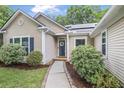 Close up of single-Gathering home featuring lush landscaping, walkway, and charming front door at 1939 Oak Tree Ln, Mount Pleasant, SC 29464