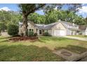 Single-Gathering home with large trees, and green grass creating a charming curb appeal at 1939 Oak Tree Ln, Mount Pleasant, SC 29464