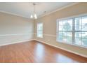 Bright dining room with hardwood floors, neutral walls, and multiple windows providing natural light at 195 Highwoods Plantation Ave, Summerville, SC 29485