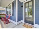 Inviting front porch showcasing a cozy seating area and a welcoming entrance at 203 Plowden Mill Ct, Summerville, SC 29485
