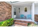 Cozy front porch with seating, perfect for relaxing, with brick accents at 204 Runnymede Ln, Summerville, SC 29485