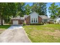 Attractive single-Gathering house with a long driveway and green lawn at 204 Runnymede Ln, Summerville, SC 29485
