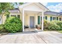 Inviting entrance with a covered porch, gray door, and well-maintained landscaping adds curb appeal at 210 Allen Richard Ct # A&B, Moncks Corner, SC 29461