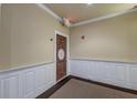 Hallway featuring neutral walls with white wainscoting and a decorative front door at 2244 Ashley Crossing Dr # 532, Charleston, SC 29414