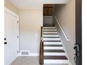 Bright entryway with staircase featuring dark wood treads and white risers, leading to the upper level at 225 Slipper Shell Ct, Mount Pleasant, SC 29464