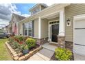 Inviting front entry with stone accents and a well-maintained garden at 227 Spectrum Rd, Summerville, SC 29486