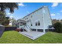 Spacious backyard featuring a wooden deck, lush green lawn, and mature trees, perfect for outdoor living at 2292 Skyler Dr, Mount Pleasant, SC 29466