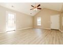 Bright, open living area with vaulted ceilings, neutral walls, and light wood-look flooring at 258 Trickle Dr, Summerville, SC 29483