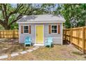 Charming back house with a yellow door and shutters, complemented by cozy outdoor chairs at 2678 Ranger Dr, North Charleston, SC 29405
