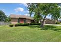 This brick home with mature trees on a well-maintained lawn offers great curb appeal in a serene setting at 2912 Doncaster Dr, Charleston, SC 29414
