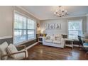 Bright living room with hardwood floors, featuring a comfortable sofa, side tables, and natural lighting at 2916 Shadow Ln, North Charleston, SC 29406