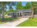 Attractive single-story home with brick and vinyl siding, complemented by a neat front lawn at 300 Oklahoma Pl, Ladson, SC 29456