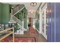 Inviting entryway with elegant staircase, stylish decor, and hardwood floors, creating a warm welcome at 3046 Sweetleaf Ln, Johns Island, SC 29455