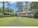 Well-kept brick home with a verdant lawn and ample natural light at 308 Ashley Dr, Summerville, SC 29485