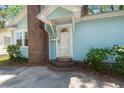Close-up of charming entrance with brick steps and well-maintained landscaping at 309 Padgett Loop, Walterboro, SC 29488
