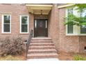 Close-up of the front entrance with brick steps, a dark wood door, and decorative details at 320 Compton Xing, Summerville, SC 29485