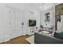 Bright living room featuring a white doorframe, a flat-screen TV, and a view to the outside at 33 Pitt St # 3, Charleston, SC 29401
