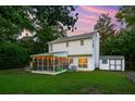 Spacious backyard featuring a screened porch, lush green lawn, storage shed, and raised garden beds at 334 Mossy Oak Way, Mount Pleasant, SC 29464