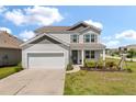 Charming two-story home with a well-manicured lawn and attached two-car garage at 411 Bering Ln, Summerville, SC 29486