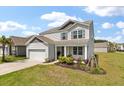 Charming two-story home featuring a well-manicured lawn, landscaping and attached two-car garage at 411 Bering Ln, Summerville, SC 29486
