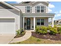 Inviting two-story home featuring a cozy front porch and well-maintained landscaping at 411 Bering Ln, Summerville, SC 29486