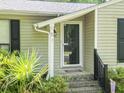 Close up of the home's front porch showing the front door and landscaping at 5 Drummond Ct, Charleston, SC 29414