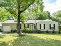 Inviting single-story home boasts a lush green lawn and mature trees providing shade at 5 Drummond Ct, Charleston, SC 29414