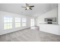 Open-concept living space with modern finishes, including a view of the kitchen and large windows at 5042 Thornton Dr, Summerville, SC 29485