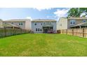 A large, well-maintained backyard with a screen porch and fenced perimeter, perfect for outdoor activities at 5138 Preserve Blvd, Ladson, SC 29456