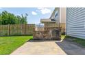 Outdoor kitchen featuring a built-in grill on a stone base, perfect for entertaining in the backyard at 5138 Preserve Blvd, Ladson, SC 29456