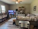 Comfortable living room with a ceiling fan, neutral walls, and a comfortable sofa with decorative pillows at 677 Redbud Ln, Summerville, SC 29486