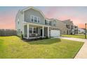 Charming two-story home with a stone facade, front porch, and well-manicured lawn at 705 Squire Pope Rd, Summerville, SC 29486