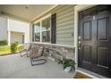Inviting front porch features stone accents, seating, and a welcoming entrance at 705 Squire Pope Rd, Summerville, SC 29486