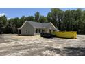 Single-story home with a covered porch, gray siding, black shutters and a large lot surrounded by green trees at 729 Burlington Rd, Walterboro, SC 29488
