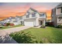 Traditional two-story home with a two-car garage, a well-kept lawn, and neutral siding at 743 Redbud Ln, Summerville, SC 29486