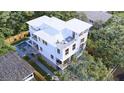 Stunning aerial view of a three-story house surrounded by lush greenery and a privacy fence at 814 Palm Blvd, Isle of Palms, SC 29451