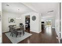 Bright dining area with dark wood floors, a modern table, and a stylish wreath decoration at 9088 Parlor Dr, Ladson, SC 29456