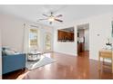 Comfortable living room with hardwood floors, ceiling fan, and easy access to the backyard at 9747 Seed St, Ladson, SC 29456