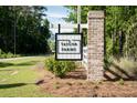 Community sign for Taylor Farms in a wooded area, with brick columns and a white fence at 1014 Peridote Way, Ladson, SC 29456