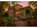 Landscaped backyard featuring an arbor, patio with bench, and manicured greenery at 106 Sago Palm Ct, Summerville, SC 29483