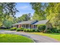 Beautiful brick home with manicured landscaping and a welcoming driveway on a sunny day at 108 E Walker Dr, Summerville, SC 29483