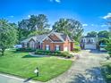 Beautiful brick home with an expansive driveway and a detached garage in a serene setting at 1111 Ole South Ct, Moncks Corner, SC 29461