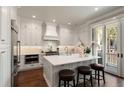 Bright kitchen boasts white cabinets, marble countertops, stainless steel appliances, and a central island at 122 Beaufain St # C, Charleston, SC 29401