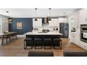 Modern kitchen features a large center island with seating, stainless appliances, and stylish pendant lighting at 1234 Captain Rivers Dr, Charleston, SC 29412