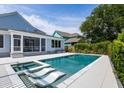Backyard boasts a pristine pool with sun loungers and a hot tub, plus a screened-in porch at 1234 Captain Rivers Dr, Charleston, SC 29412