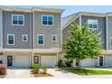 Townhome exterior with attached garage, landscaped yard, and modern architectural details at 1242 Allusion Ln # 206, Mount Pleasant, SC 29466