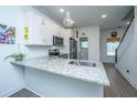 Modern kitchen featuring granite counters, stainless steel appliances, and pendant lighting at 1242 Allusion Ln # 206, Mount Pleasant, SC 29466