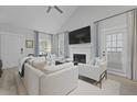 Bright living room featuring a fireplace, vaulted ceilings, and modern decor at 1308 Cadet Ct, Mount Pleasant, SC 29466