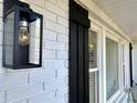 Close-up of the front of the house featuring shutters and lantern at 1329 Camp Rd, Charleston, SC 29412